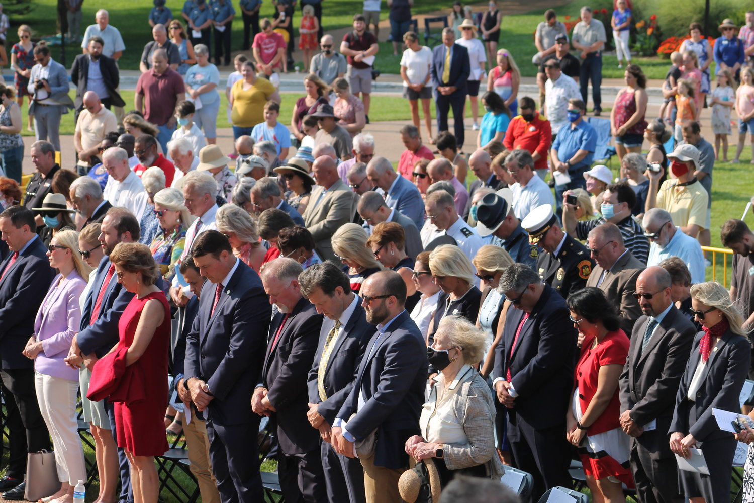 Participants in the Aug. 10 Statehood Day festivities at the Capitol bow their heads during the Invocation.